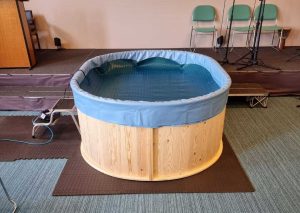 Wooden baptistry in a church ready for baptism.
